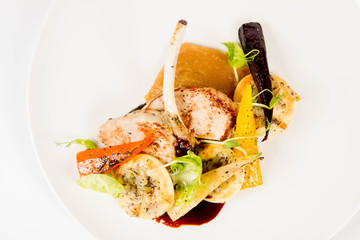 Meat dish with vegetables on a white background