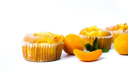 Apricot muffins with fresh fruit on white