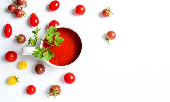 Ketchup and small cherry tomatoes on white background