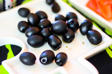 black olives on a white plate