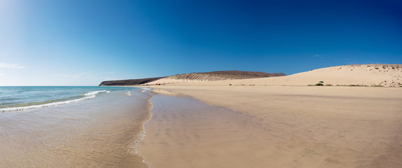 wave of blue ocean on sandy beach. Background.