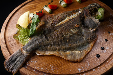 Fish flounder with lemon and vegetables