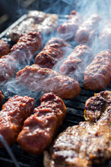 Close up pf delicious chicken breast on wooden skew with fresh vegetables, garlic, paprika fried on mangal barbeque grill