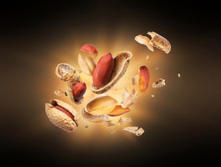Dried peanut crushed in the air on black background