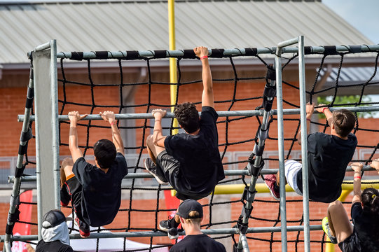 Athletes Competing On An Obstacle Course