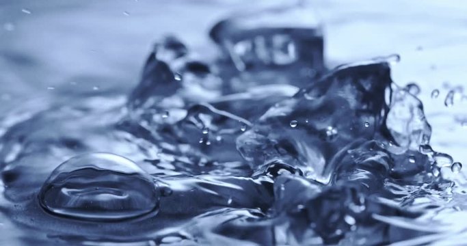 Ice cubes fall in water. Water splash. Slow motion 2k video shooted on 240 fps