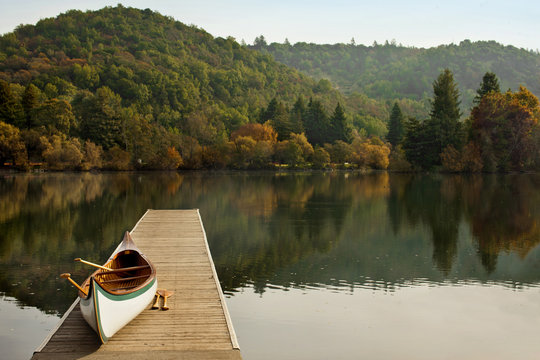 View of canoe on wooden pier during autumn