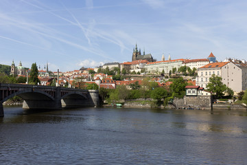 Spring green Prague Lesser Town with gothic Castle above River Vltava in the sunny Day, Czech Republic