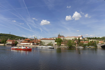 Fototapeta na wymiar Spring green Prague Lesser Town with gothic Castle above River Vltava in the sunny Day, Czech Republic