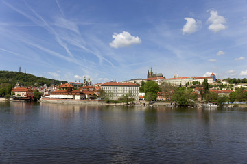 Naklejka na ściany i meble Spring green Prague Lesser Town with gothic Castle above River Vltava in the sunny Day, Czech Republic