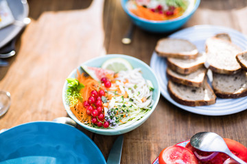 Close-up on a colorful salad in a bowl on a wooden table