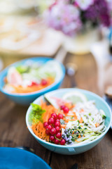 Close-up on a colorful salad in a bowl on a wooden table