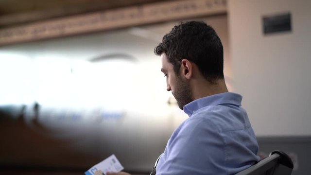 Guy checking boarding pass on airport