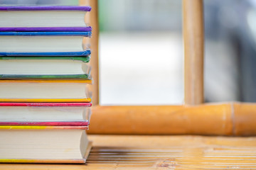 Books stack on the wooden chair for business, education back to school concept.