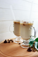 Two cups of ice coffee with coffee beans on wooden table, selective focus. summer delicious drink
