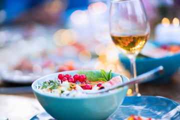 Close-up on a colorful salad in a bowl on a wooden table