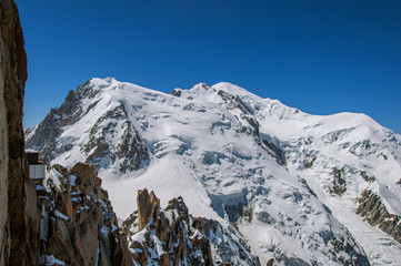 Snowy Mont Blanc in a sunny day, viewed from the Aiguille du Midi, near Chamonix. A famous ski resort located in Haute-Savoie Province, at the foot of Mont Blanc in the French Alps.