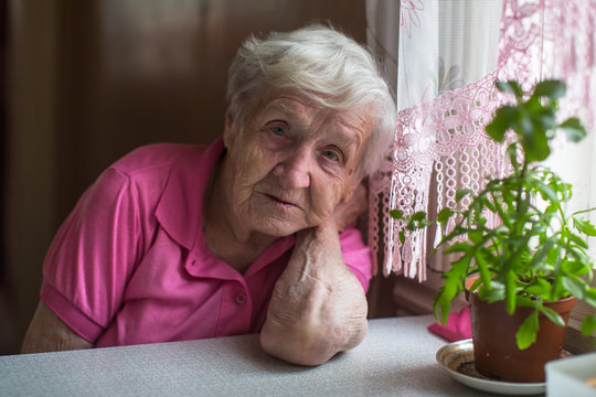 Elderly woman pensioner in the kitchen portrait.