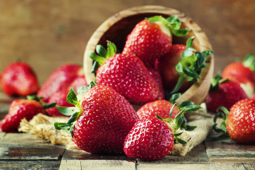 Fresh red strawberry, vintage wooden background, selective focus
