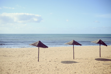 Fototapeta na wymiar Beach Umbrella - tropical holiday tranquility background. Sunny outdoors seascape