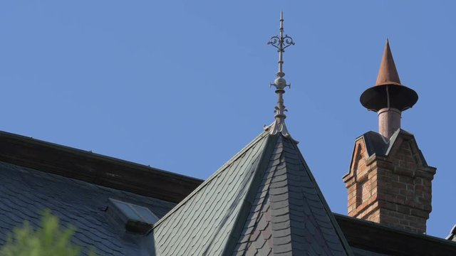 Lightning rod and a chimney on a roof
