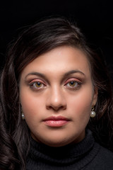 Portrait of a young woman with clean skin on a black background