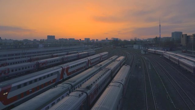 trains on a large railway junction at sunset