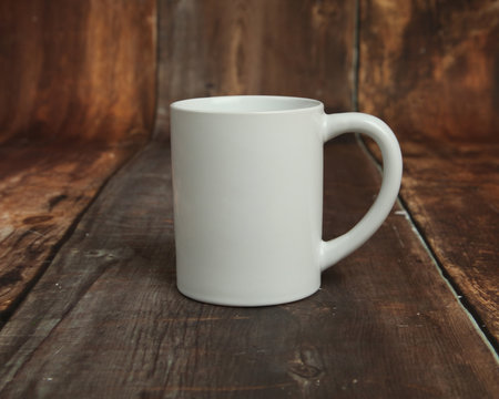 Blank white mug mockup photo on rustic wood