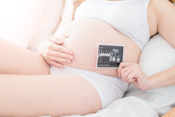 woman holding baby ultrasound