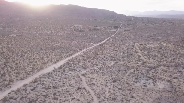 Desert sunset drone ascending