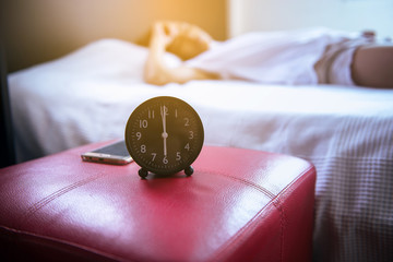 Young asian woman hates getting stressed waking up early 6 o'clock,Close up of alarm clock with...