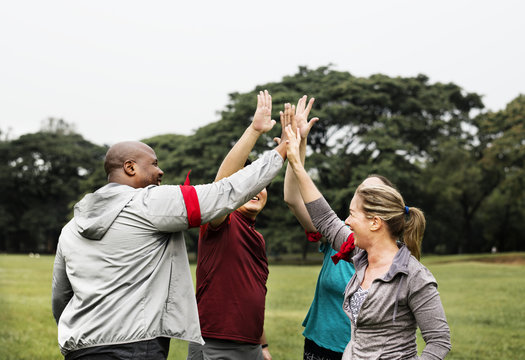 Diverse people making a high five