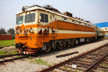 Fototapeta na wymiar Old out of date rust yellow train locomotive