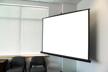 White projector screen and monitor in the meeting room