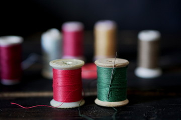 Colorful yarns, strings with reels close up.