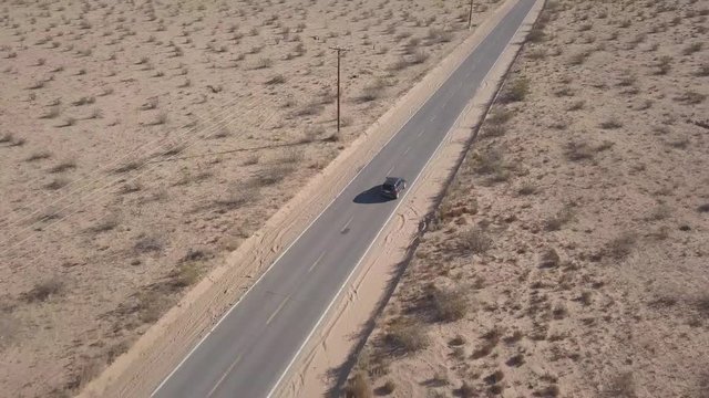 Long desert road highway drone tracking vehicle