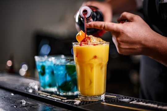 Bartender is preparing orange cocktail