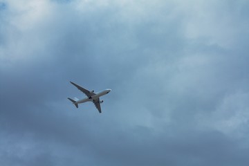 transport airplane in the cloudy sky, bottom view
