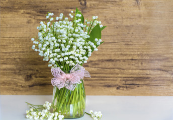 Lily of the Valley Bouquet in Glass Vase .Spring Flowers Background
