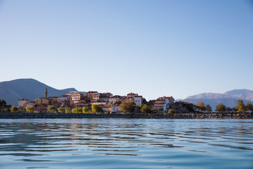 buildings on coast and beautiful mountains behind, lake egirdir, turkey