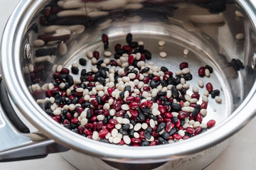 Black, white, burgundy beans in a large saucepan
