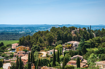 Panoramic of Provence hills seen from the village of Chateauneuf-du-Pape, with roofs, trees, blue sky and sunny day. In the Vaucluse department, Provence-Alpes-Côte d'Azur region, southeastern France