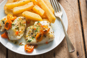 Cod fillets with cherry tomato, white wine & basil dressing served with chips
