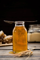Linden honey in a transparent glass bottle