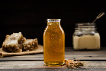 Linden honey in a transparent glass bottle