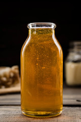 Linden honey in a transparent glass bottle