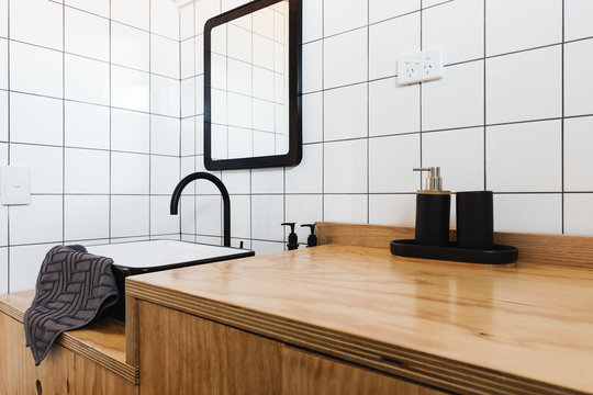 Bathroom Vanity Of Wood With Black Basin And Taps