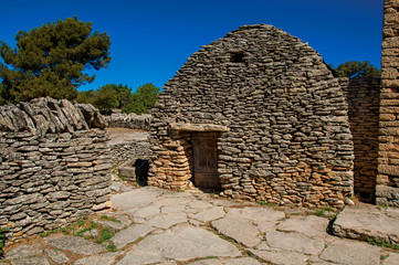 Typical hut made of stone with sunny blue sky, in the Village of Bories, near the town of Gordes. Located in the Vaucluse department, Provence  region, in southeastern France