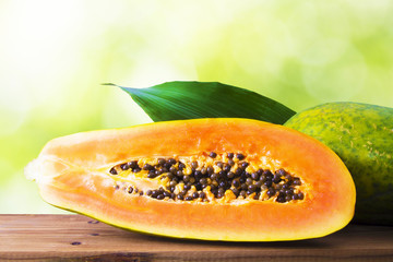 slice of papaya with green background