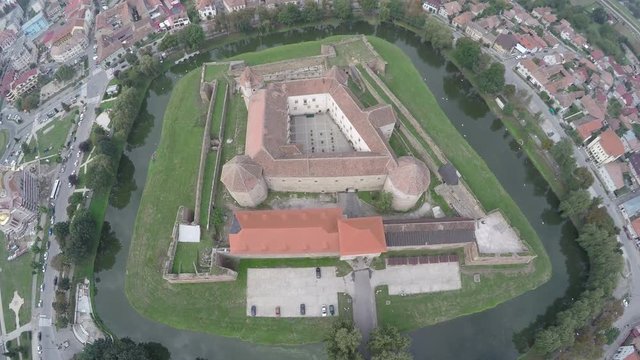 Aerial view of Fagaras Fortress surrounded by water